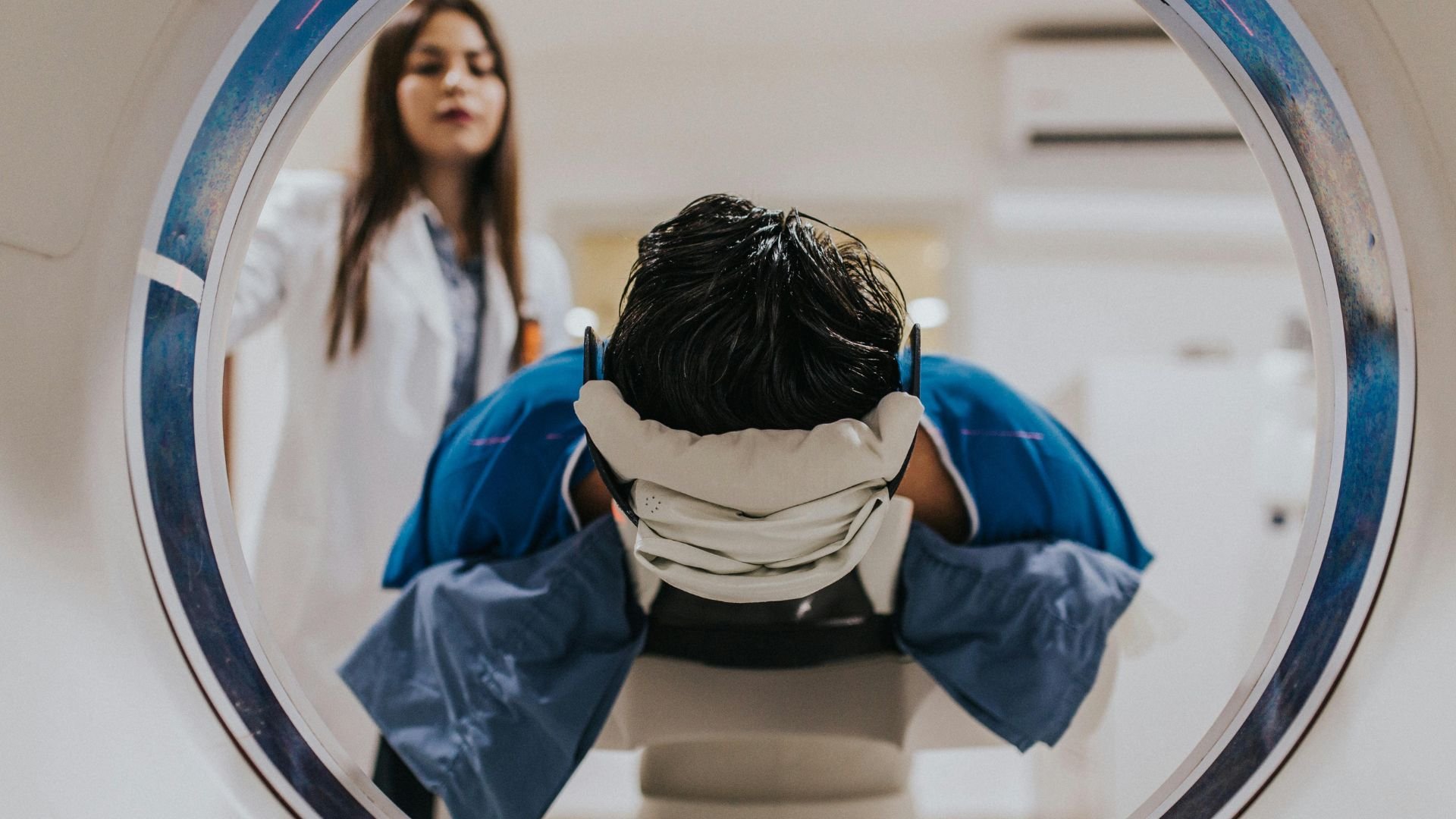 Radiologist talking a patient through an MRI