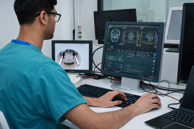 Radiologist talking a patient through an MRI